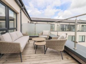 a balcony with a couch and chairs and a table at Apartment 20, River View in Preston