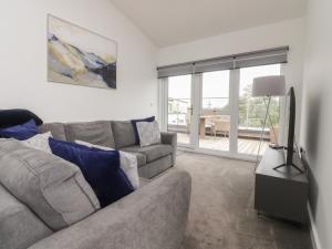 a living room with a couch and a television at Apartment 20, River View in Preston
