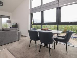 a living room with a table and chairs and a couch at Apartment 20, River View in Preston