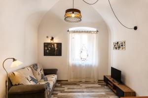 a living room with a couch and a window at B&B Interno SG in LʼAquila
