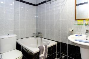 a bathroom with a tub and a toilet and a sink at Aphrodite Hotel Syros in Kini +52 photos