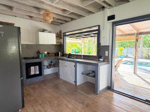 a kitchen with a sink and a counter top at Moorea Fare Korail in Temae