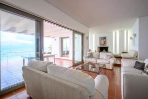a living room with a view of the ocean at Horizon House - Beachfront Escape in Nerántza