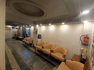 a waiting room with a bunch of chairs and a wall at Hotel Mount View in Shimla