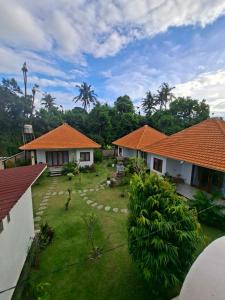 an image of a yard with two houses at Rumah Asri Devarastra #1 in Amed +7 photos