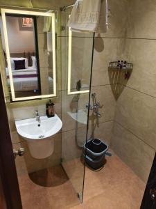 a bathroom with a sink and a shower with a mirror at Ramnaa Hotel in Jāmb +28 photos
