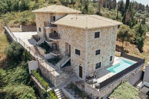 an aerial view of a stone house with a swimming pool at Lambda Luxury Villa 2 in Syvota