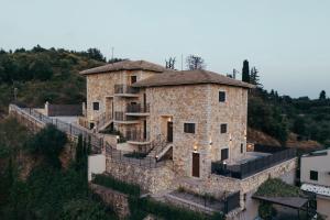 a large stone building on top of a hill at Lambda Luxury Villa 2 in Syvota
