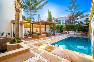 a swimming pool with a gazebo next to a building at Villa 33 Ultra Lux High-End in Tangier
