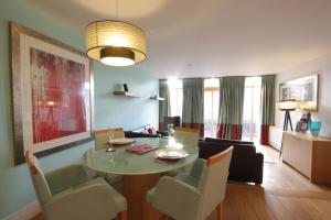 a dining room and living room with a table and chairs at By The Bridge Apartments in Inverness