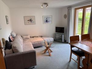 a living room with a couch and a table at Haus Ricarda in Lech am Arlberg