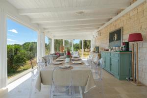 a kitchen and dining room with a table and chairs at Trullo Theodoro Puglia in Ceglie Messapica