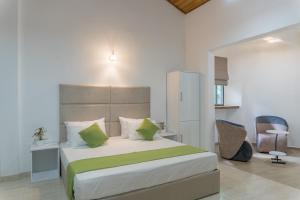 a bedroom with a large bed and a chair at Ditara in Katugastota