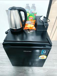 a tea kettle and chips on top at Cloud Bed Ao Nang- High Speed internet, Comfort bed , Smart Tv in Ao Nang Beach