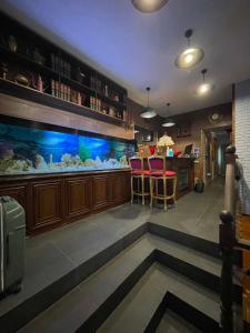 a bar with a fish tank in a restaurant at Villa Rinat in Kyiv