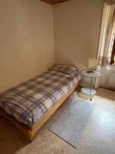 a bedroom with a bed and a small table at pensione VAIS in Piotta