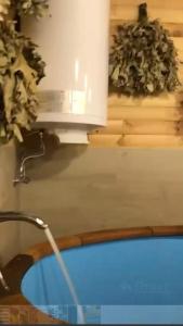 a bath tub with a faucet in a room at Villa Rinat in Kyiv