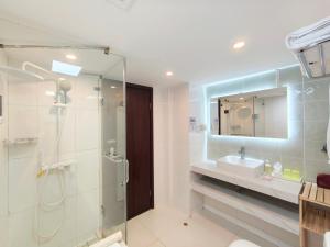 a bathroom with a glass shower and a sink at Shanghai Cosmo World Union Service Apartment in Shanghai +63 photos
