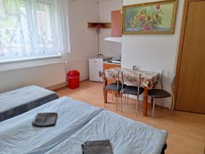 a small room with a table and a table and chairs at Modrý dom in Vitanová