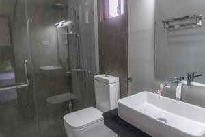a bathroom with a toilet and a sink and a shower at Ditara in Katugastota