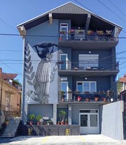 a building with a mural of a woman on it at Stojanovski Apartments in Kumanovo