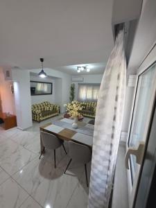 a living room with a table and a couch at Garyfallia's House in Korifásion