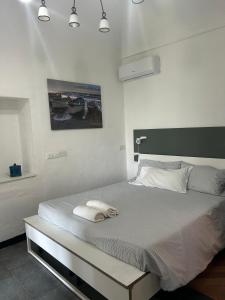a bedroom with a bed with two towels on it at Cà Bartolomeo in Finale Ligure