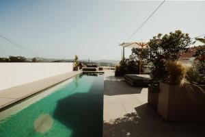 a swimming pool in the middle of a house at Suites D´aldeia - Suite 20 in Mafra