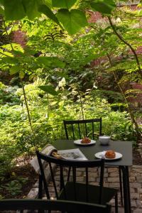 a green table with two plates of food on it at Wilmina Hotel in Berlin
