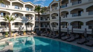 an image of the courtyard of a hotel with a swimming pool at Zante Atlantis Hotel in Laganas