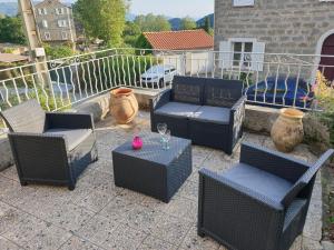 a group of chairs and tables on a patio at Studio de la maison Lilas in Pila-Canale