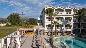 a hotel with a swimming pool in front of a building at Zante Atlantis Hotel in Laganas