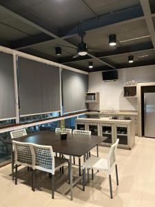 a kitchen with a table and chairs in a room at White Rock Lodge in Nusa Dua