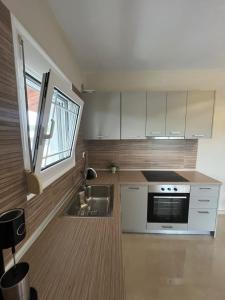 a kitchen with a sink and a stove at Sky Apartment in Ofrínion