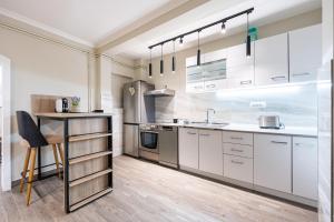 a kitchen with white cabinets and a table at Villa Dorotea in Tivat +13 photos
