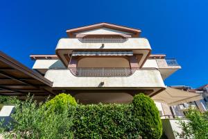 a building with balconies on the side of it at Villa Dorotea in Tivat