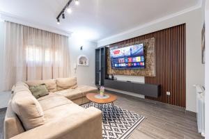 a living room with a couch and a flat screen tv at Villa Dorotea in Tivat