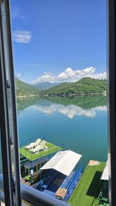 a view of a lake from a window at Captains Seherzada Apartment in Železnička Stanica Ostrožac