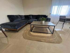 a living room with a couch and a coffee table at Sky Apartment in Ofrínion
