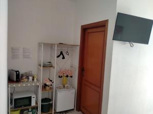 a room with a door and a television on a wall at Le Camelie camera in Bosa