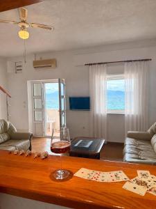 a living room with a table and a view of the ocean at Villa Ocean Breeze First Row in Brist