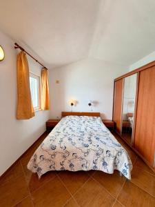 a bedroom with a bed with a blue and white bedspread at Villa Ocean Breeze First Row in Brist