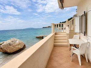 a balcony of a house with a view of the ocean at Villa Ocean Breeze First Row in Brist