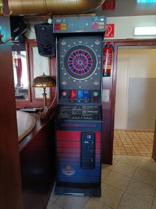a game machine with a dart board in a room at Double Room Stegersbach in Stegersbach