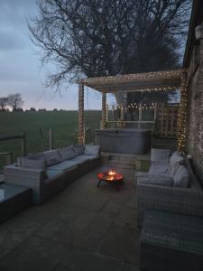 a patio with couches and a table and a pergola at The Barn in Crumlin +20 photos