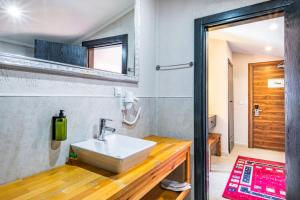 a bathroom with a sink on a wooden counter at Çınar Butik Hotel in Kaş +57 photos
