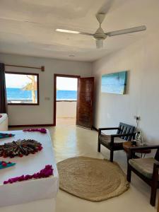 a living room with a couch and a table and chairs at AVO Boutique Hotel in Dikoni
