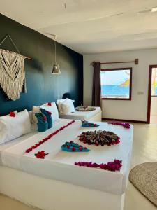 a large bed with flowers on it in a room at AVO Boutique Hotel in Dikoni +50 photos