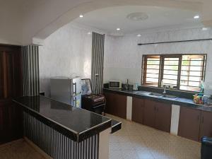 a kitchen with a counter top and a refrigerator at Diani family friendly in Diani Beach