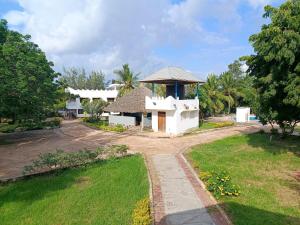 a white house with a gazebo at Diani family friendly in Diani Beach